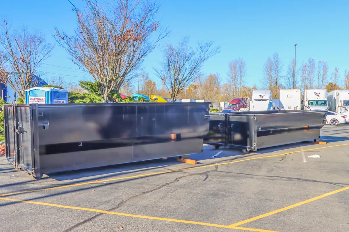 Professional dumpster rental service with roll-off container on residential driveway in Winter Park